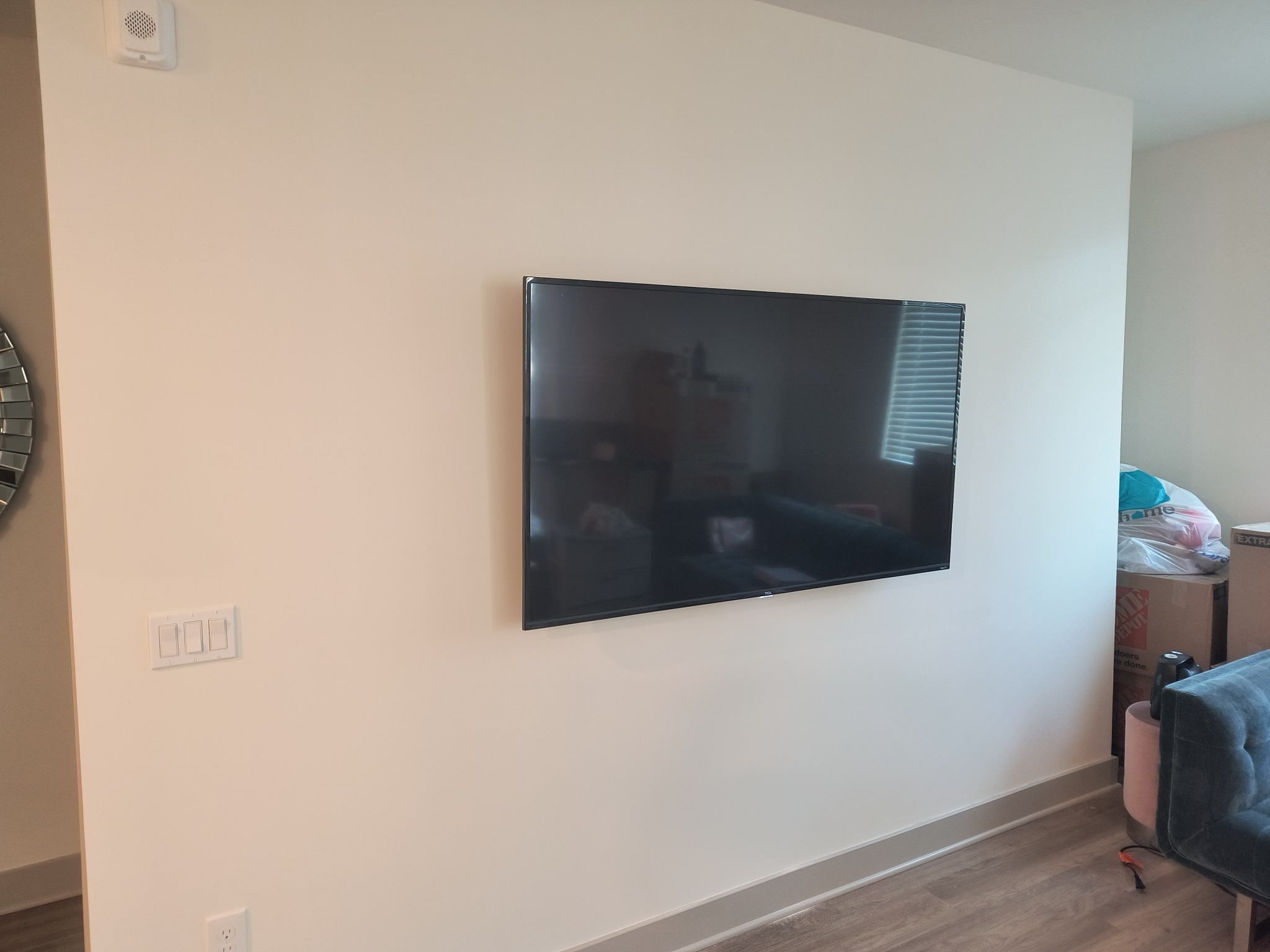 Completed TV mounting on a light-colored wall